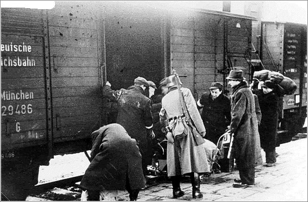 A german soldier looks on as Jews are forced to board the deportation train from Krakow
